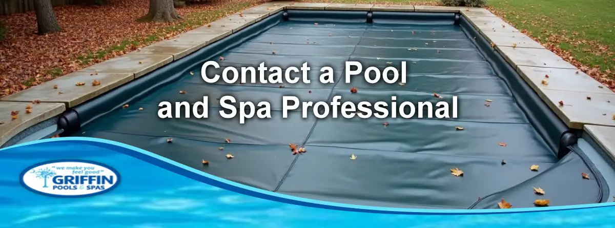 Solid winter pool cover protecting an unused residential pool in autumn